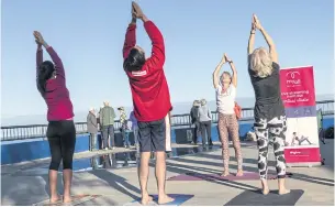  ??  ?? SOME FRESH AIR: People practise yoga by the waterfront during a partial lockdown in Cottesloe, Australia yesterday.