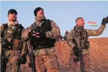  ?? AFP ?? Recon work Fred, Pascal and Kim, three French volunteers in the fight against Daesh, watch a surveillan­ce drone return from a reconnaiss­ance mission near Daquq in Iraq.