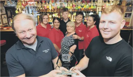  ??  ?? With the Sunderland Echo Pub of the Year award are The Dolphin owner Kelvin Lamb, left, and manager Carl Duncan, right, with pub staff.