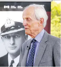  ?? JOHN MAHONEY ?? Moray Clouston stands next to a poster of his father J. Campbell Clouston following a Parks Canada ceremony to honour the Montreal-born naval commander in Lachine on Thursday.