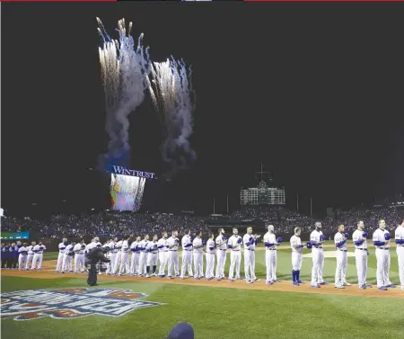  ?? | JONATHAN DANIEL/ GETTY IMAGES ?? Fireworks erupt during the national anthem before the Cubs- Dodgers game Monday atWrigley Field.