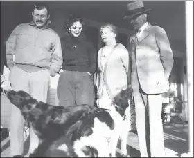  ?? (Special to the Democrat-Gazette) ?? Ernest Hemingway stands on the front porch of his in-laws’ home in Piggott in 1932 with Pfeiffer cousin Barbara Peck (second from left) and Paul and Mary Pfeiffer, parents of Pauline Pfeiffer. Around Piggott, the famous writer was best-known to the locals as Paul Pfeiffer’s son-in-law.