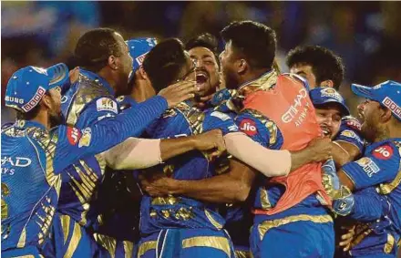  ?? AFP PIC ?? Mumbai Indians cricketers celebrate their victory against Rising Pune Supergiant in the IPL final on Sunday.
