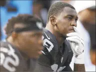  ?? Ben Margot / Associated Press ?? Raiders linebacker Aldon Smith, right, sits on the bench during a game against the Bengals in 2015. Smith will be able to take part in team activities with the Cowboys after the NFL on May 20 conditiona­lly reinstated the pass rusher from an indefinite suspension for off-field issues.