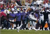  ?? SUE OGROCKI — THE ASSOCIATED PRESS ?? Kansas State running back Deuce Vaughn (22) avoids a tackle by Oklahoma defensive lineman Perrion Winfrey, left, as he carries for a touchdown in the second half Saturday in Norman, Okla.