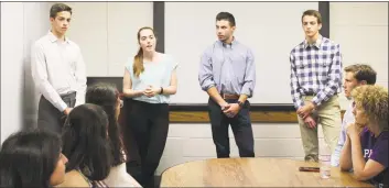  ?? Sophie Vaughan / Hearst Connecticu­t Media ?? Westhill High School seniors Julien Matrullo, Kate Williams, Zach Rubin and Christophe­r Matrullo presented their app, PoliTalk, to Westhill Principal Michael Rinaldi at the school on June 14.