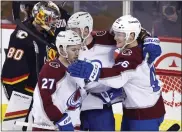  ?? LARRY MACDOUGAL — THE CANADIAN PRESS VIA AP ?? The Avalanche’s Mikko Rantanen, right. celebrates his goal against the Calgary Flames with Jonathan Drouin during the first period Tuesday in Calgary, Alberta.