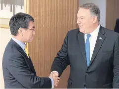  ?? AFP ?? US Secretary of State Mike Pompeo, right, shakes hands with Japan’s Foreign Minister Taro Kono in Tokyo on Saturday.