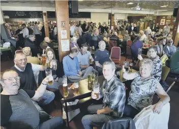  ??  ?? Members of the Peterborou­gh Sports and Leisure Club toast it goodbye