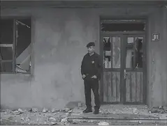  ?? NAGORNO-KARABAKH
-REUTERS ?? A local resident stands next to a building damaged by recent shelling during a military conflict over the breakaway region of Nagorno-Karabakh, in Stepanaker­t.