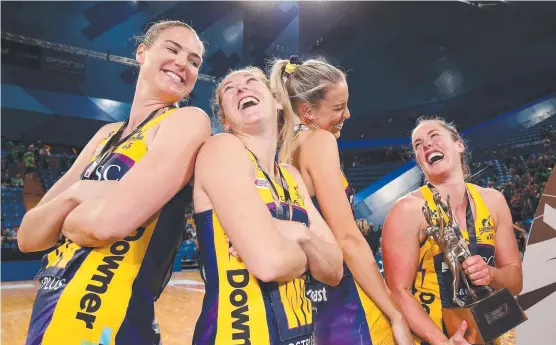  ?? WINNING SMILES: Lightning players, including Townsville’s Cara Koenen ( second from right), celebrate their second consecutiv­e Super Netball grand final victory. ??
