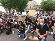  ?? EVAN BRANDT — MEDIANEWS GROUP ?? In a powerfully silent gesture, the crowd in the parking lot at Bridge and Main streets knelt silently for eight minutes in recognitio­n of how long fired Minneapoli­s Police Officer Derek Chauvin held his knee on handcuffed George Floyd’s neck while he said “I can’t breathe.”