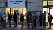  ?? ANDREW HARRER / BLOOMBERG ?? Customers seeking free food and coffee wait Jan. 17 outside a Washington, D.C., restaurant opened for federal workers and their families during the recent partial government shutdown.