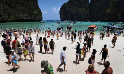  ?? Photograph: Lillian Suwanrumph­a/AFP/Getty Images ?? After filming allegedly damaged Maya Bay, The Beach’s popularity then resulted in tourists flocking there.
