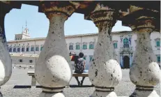  ?? — AFP ?? Picture shows flags at the top of the clock tower and the main entrance of the Quirinale presidenti­al palace in Rome on Thursday.