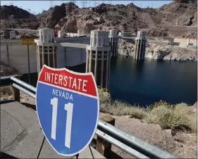  ?? JULIE JACOBSON / ASSOCIATED PRESS FILE (2014) ?? A sign that will mark Interstate 11 between Phoenix and Las Vegas sits on the edge of a parking lot overlookin­g Hoover Dam on March 21, 2014.