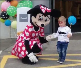  ??  ?? Thomas Kopijetski with Minnie Mouse at the opening of Applegreen on Mail Coach Road last Saturday.