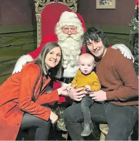  ??  ?? Little Milo, with parents Tazmin and James, was able to meet Santa Claus