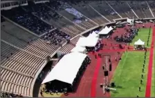  ??  ?? FAREWELL TO A TYRANT: The body of Robert Mugabe is taken into Harare’s National Sports Stadium for his funeral, far left – but the venue was less than half full, with row upon row of seats lying empty, left