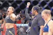  ?? JOHN LOCHER/ASSOCIATED PRESS ?? Amanda Nunes, left, celebrates her victory over a slumping Ronda Rousey, right, in the main event of UFC 207 on Friday night in Las Vegas, Nev.