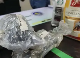  ?? PHOTOGRAPH COURTESY OF BOC ?? THREE plastic packs of kush marijuana with an estimated value of P1.1 million were found concealed inside imported coffee packs from California by the Bureau of Customs.