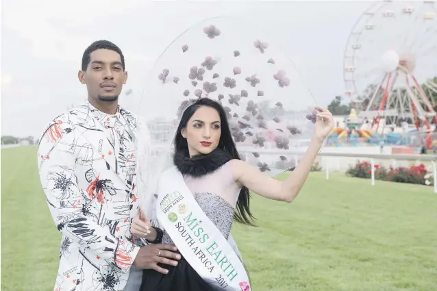  ?? Picture: Refilwe Modise ?? EARTHY COUPLE. Model Daniel Dlamini and Miss Earth 2017 Irini Moutzouris are pictured at the Turffontei­n Racecourse ahead of today’s Sansui Summer Cup.