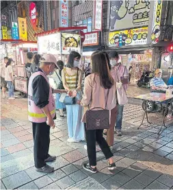  ??  ?? Life in Taipei seems almost normal, though temperatur­e checks, masks and hand sanitizer are everywhere. Taiwan has been lauded for its outbreak response, which requires people to report their health status to the government regularly.