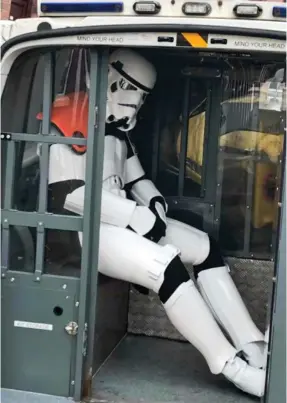  ?? ?? In a police van, far far away: The officer in his Stormtroop­er outfit