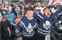  ??  ?? THE MOMENT THAT TELLS A STORY: Maple Leaf fans react after the Boston Bruins score a late third-period goal in a do-or-die Game 7 on May 14, 2013. (The Leafs lost).