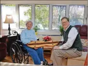  ?? PHOTO CONTRIBUTE­D BY DAN CURRAN/ATLANTA JOURNAL-CONSTITUTI­ON/TNS ?? Betty Tarr, an independen­t living resident at Wesley Woods Towers, is shown here chatting with her son Sam about a handmade dulcimer that was a gift from her late husband. She didn’t wait for her children to have “the talk” with her about moving from her home in Hartwell, Ga. She knew it was no longer safe for her to live alone.