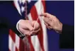  ?? Patrick Semansky/Associated Press ?? ■ President Donald Trump, left, hands a swab that could be used in coronaviru­s testing to Vice President Mike Pence during a coronaviru­s task force briefing Sunday at the White House in Washington.