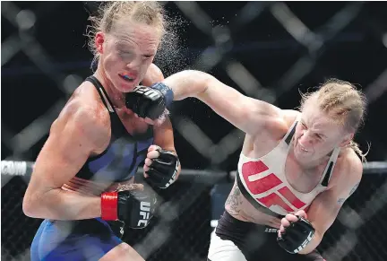  ?? — THE ASSOCIATED PRESS ?? Holly Holm, left, absorbs a punch from Valentina Shevchenko during a women’s bantamweig­ht bout at UFC Chicago. Shevchenko punched her way to a unanimous decision.