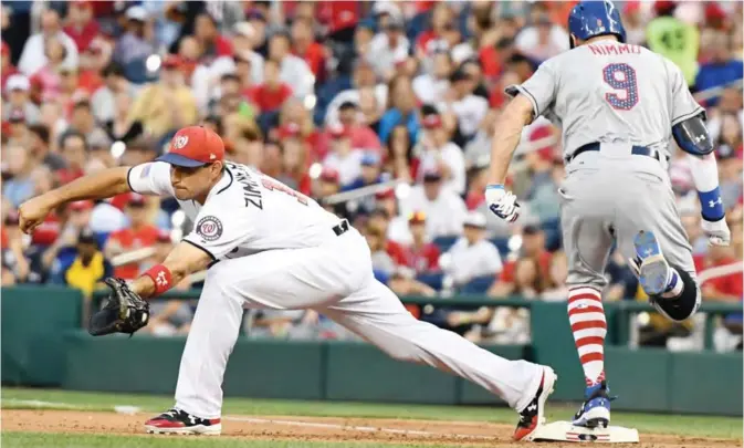  ??  ?? WASHINGTON: Brandon Nimmo #9 of the New York Mets beats the throw to Ryan Zimmerman #11 of the Washington Nationals for an infield single in the eighth inning during a baseball game at Nationals Park on Monday in Washington. — AFP