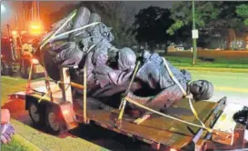  ?? AP ?? A monument dedicated to Confederat­e women being taken away in Baltimore. Leaders across various US cities said this week they would step up efforts to pull such monuments from public spaces.