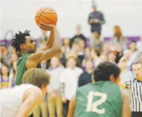  ?? Photos by Andy Cross, The Denver Post ?? Aurora Central’s Ladarius Thomas, shooting a free throw, averages 19.3 points per game, third in the Class 5A/4A East Metro League.