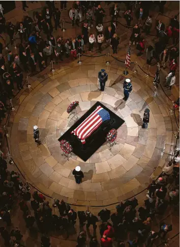  ?? Karen Warren / Staff photograph­er ?? The public files around the casket of President George H.W. Bush on Monday at the Capitol Rotunda. Bush will lie in state in the Rotunda until Wednesday morning.