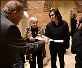  ?? ?? Turkish refugee Mari Jan, center, provides hors d’oeuvres for guests.