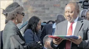  ?? PICTURE: KOPANO TLAPE GCIS ?? Deputy President Cyril Ramaphosa hands over the South African flag to the Rev Makhenkesi Stofile’s wife, Nambitha Stofile, during the funeral of the chancellor of the University of Fort Hare and former Minister of Sports and Recreation at Fort Hare in...