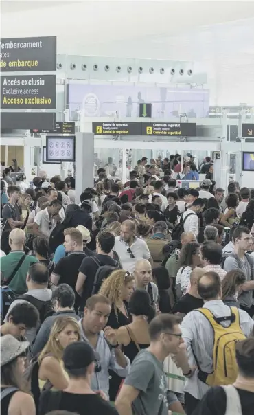  ??  ?? Thousands of passengers had to queue for hours yesterday to pass through security controls at Barcelona’s El Prat airport where guards held a series of mini-strikes in a continuing dispute over pay