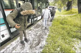  ?? LAURA A. ODA – STAFF PHOTOGRAPH­ER ?? Students from Montara Middle School play in the hail after their bus was delayed due to a hail storm on Redwood Road in Oakland on Monday. The hail snarled traffic on Highway 13 because of cars sliding on icy roads and surroundin­g streets and delayed...