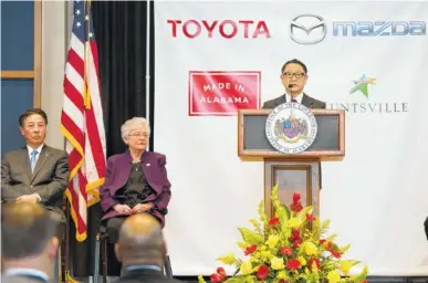  ?? THE ASSOCIATED PRESS ?? Akio Toyoda, right, of Toyota Motor Corp., speaks as Alabama Gov. Kay Ivey, center, and Masamichi Kogai, Mazda Motor Corp. president and CEO, listen during a press conference Wednesday in Montgomery, Ala., where the Japanese automakers announced plans...