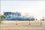  ?? David Guralnick / Associated Press ?? The Palace of Auburn Hills undergoes a controlled demolition on Saturday. Opened in 1988, the multi-use stadium was the home of the Detroit Pistons as well as numerous concerts and sporting events.