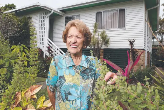  ??  ?? Norma Haydock in her Brett St garden – just 50m from where she was born. The 99-year-old is selling up to move north with family. Picture: GLENN HAMPSON