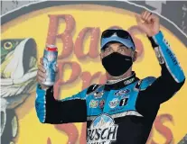  ?? STEVE HELBER/ASSOCIATED PRESS ?? Kevin Harvick celebrates in Victory Lane after driving his Ford to victory in the NASCAR Cup Series race Saturday in eastern Tennessee.