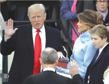  ?? — MailOnline ?? Donald Trump is sworn in as the 45th president of the United States by Chief Justice John Roberts as Melania Trump looks on during the 58th Presidenti­al Inaugurati­on in Washington yesterday.