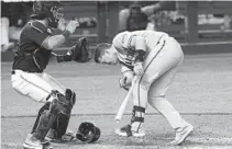  ?? MARTA LAVANDIER/AP ?? The Giants’ Buster Posey reacts after being hit by a pitch from the Marlins’ Sandy Alcantara during the seventh inning Saturday. To the left is Marlins catcher Jorge Alfaro.