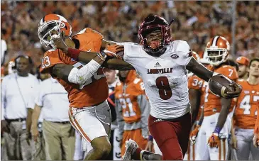  ?? RAINIER EHRHARDT / AP ?? Louisville QB Lamar Jackson ran for 162 yards and passed for 295 in a 42-36 loss to Clemson last season. “He can make any move you want,” Clemson defensive end Clelin Ferrell says, so the goal is to make him throw.