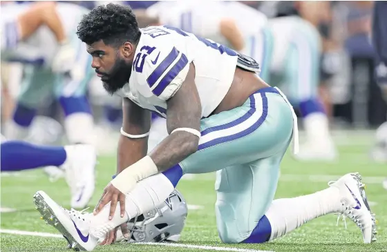  ??  ?? Cowboys running back Ezekiel Elliott warms up before a preseason game.