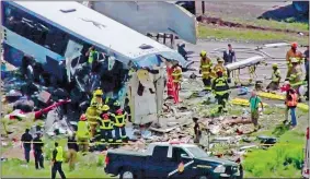  ?? KQRENEWS13 VIA AP ?? This photo from video provided by KQRENews13 shows first responders working at the scene of a collision between a Greyhound passenger bus and a semi-truck on Interstate 40 near the town of Thoreau, N.M., near the Arizona border on Thursday.