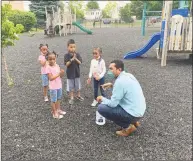  ?? Michael P. Mayko / Hearst Connecticu­t Media ?? Adiel Dominguez, a staffer who specialize­s in teaching art at Bridgeport’s Hall Neighborho­od House, reminds children to wash their hands after using the facility’s playground Tuesday. Hall Neighborho­od House reopened its early childhood and after-school programs on a limited basis after being closed since March.